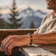 Black, grey and white stone disc bead bracelet worn on a man's wrist
