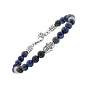 Angled view of a blue and grey stone bead bracelet with a silver-tone Hamsa hand centerpiece and textured spacers