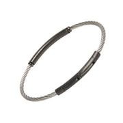 Two-tone twisted cable bracelet with a single black PVD tube bar station, highlighting the secure push-clasp closure.